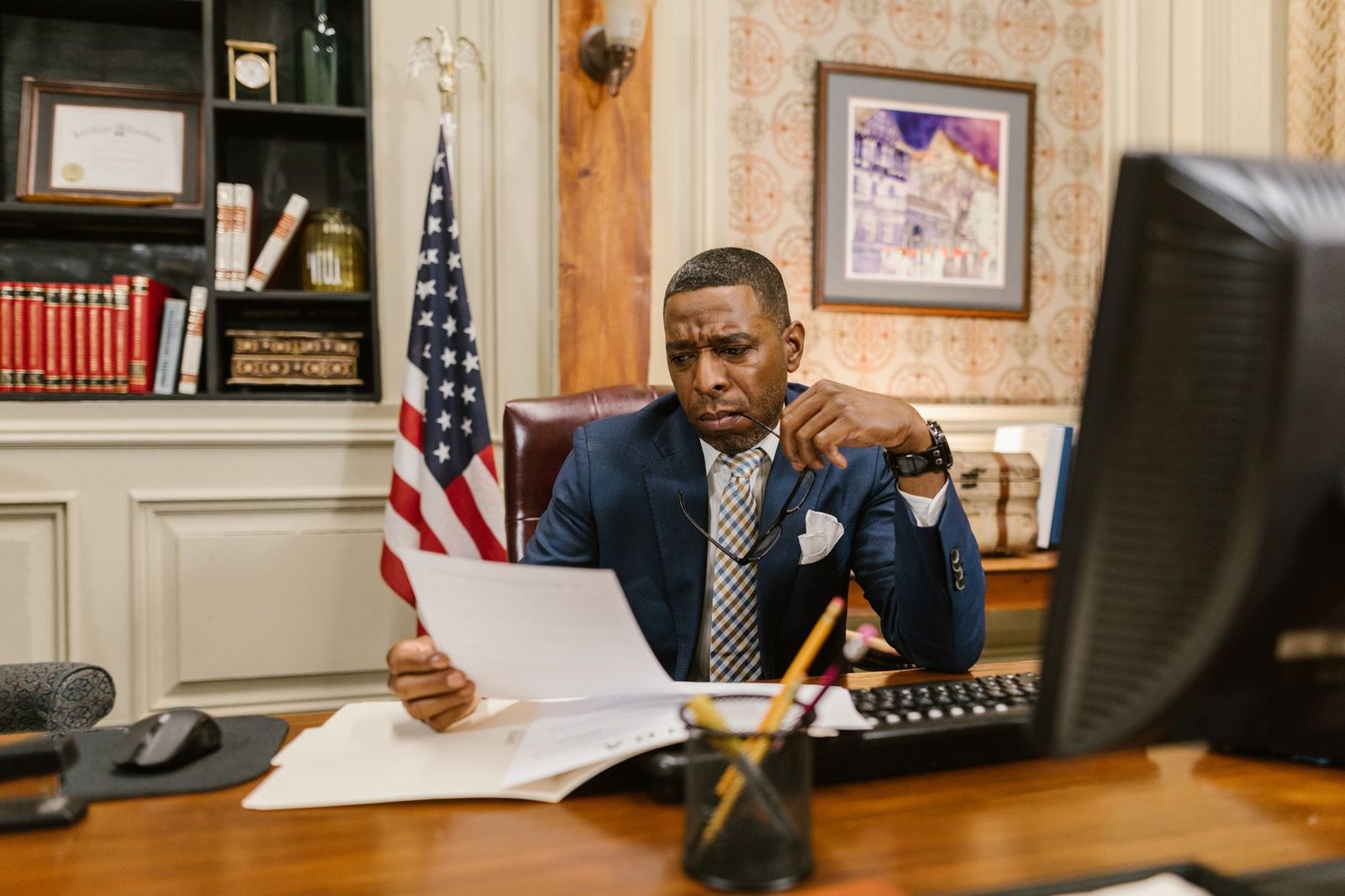 A focused lawyer reviews documents at a desk, representing professional legal counsel for Broward County businesses.