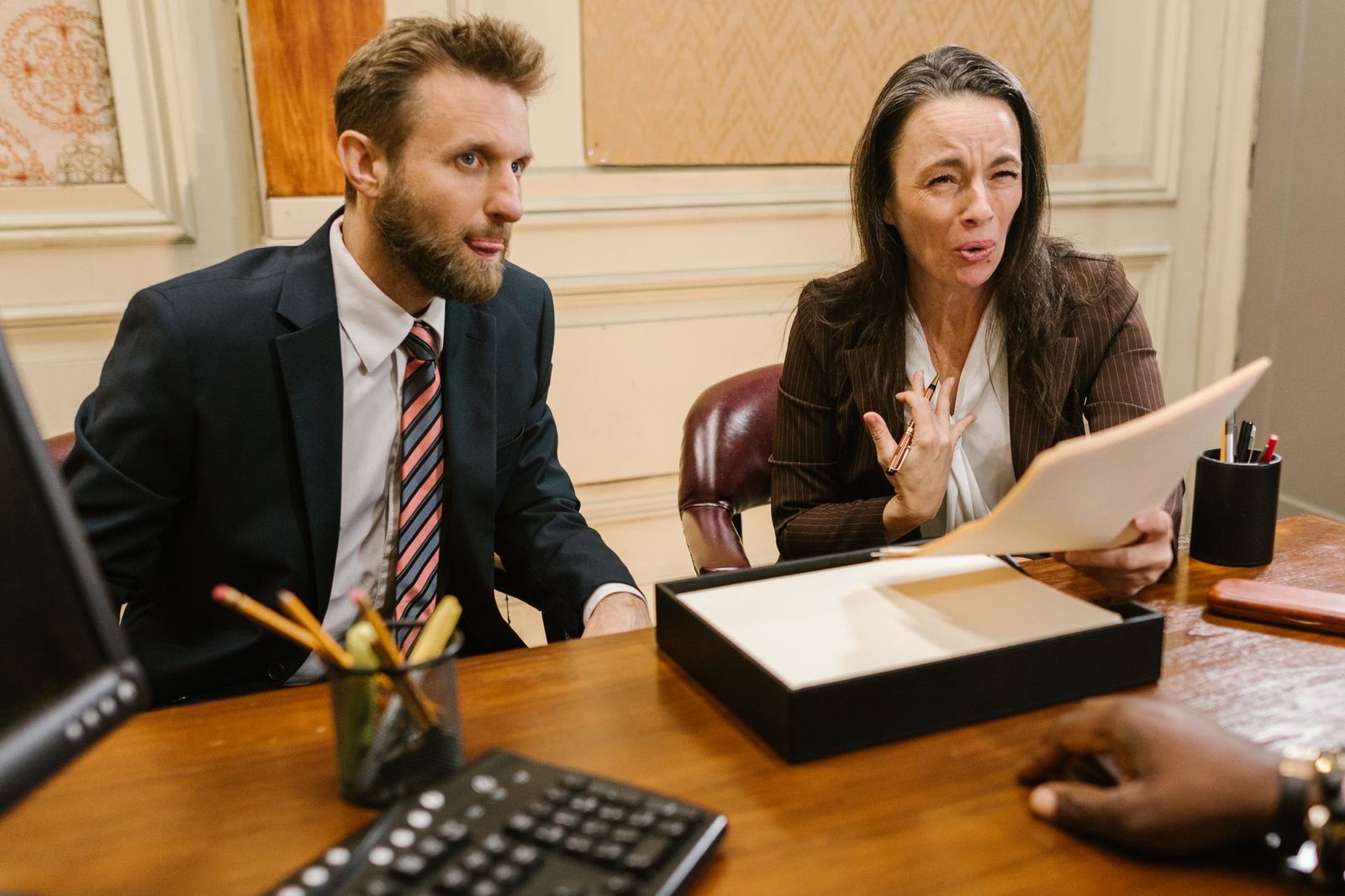 Two lawyers review legal documents together at a desk in a professional Florida office.