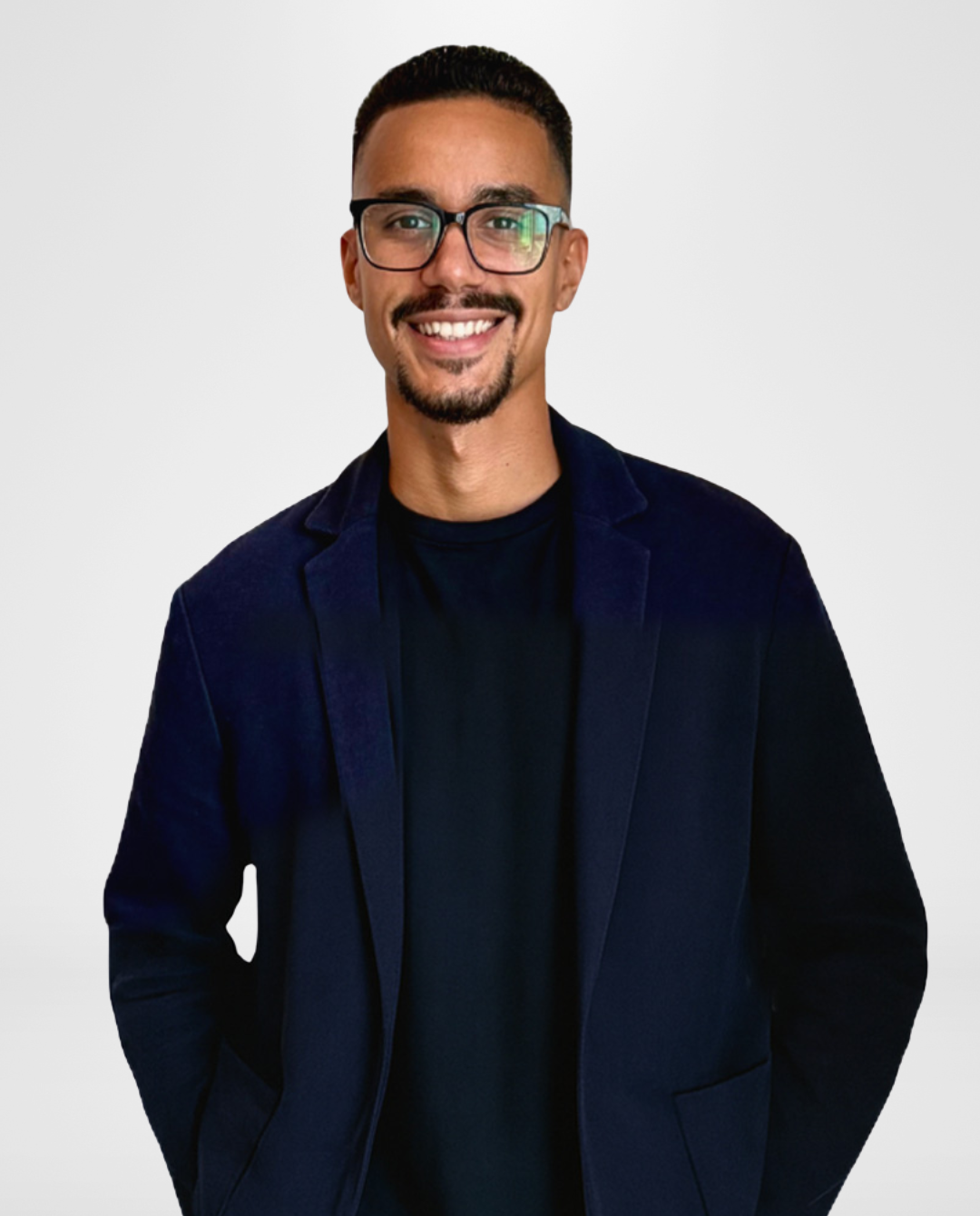 Smiling man wearing glasses and a navy blazer