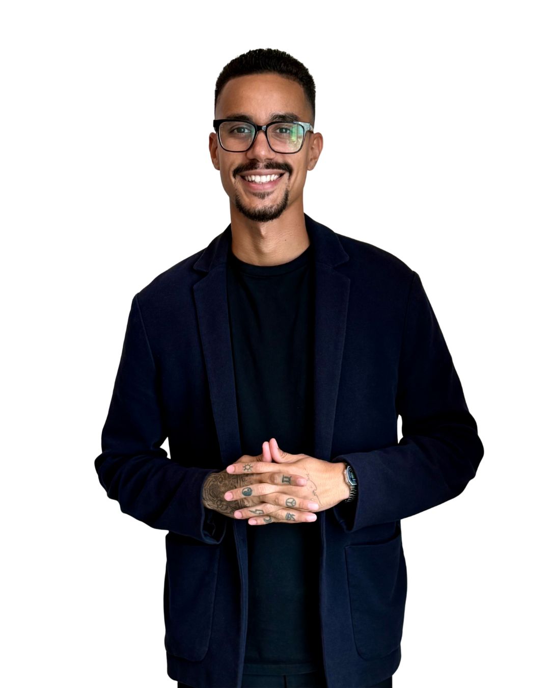 Smiling person with glasses, wearing a dark suit.