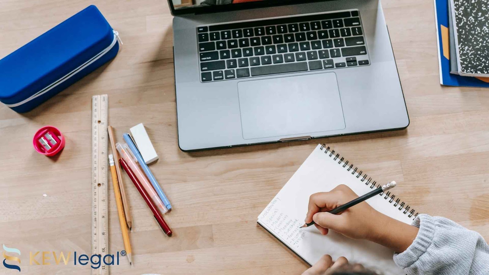 Writing notes on desk with laptop and stationery