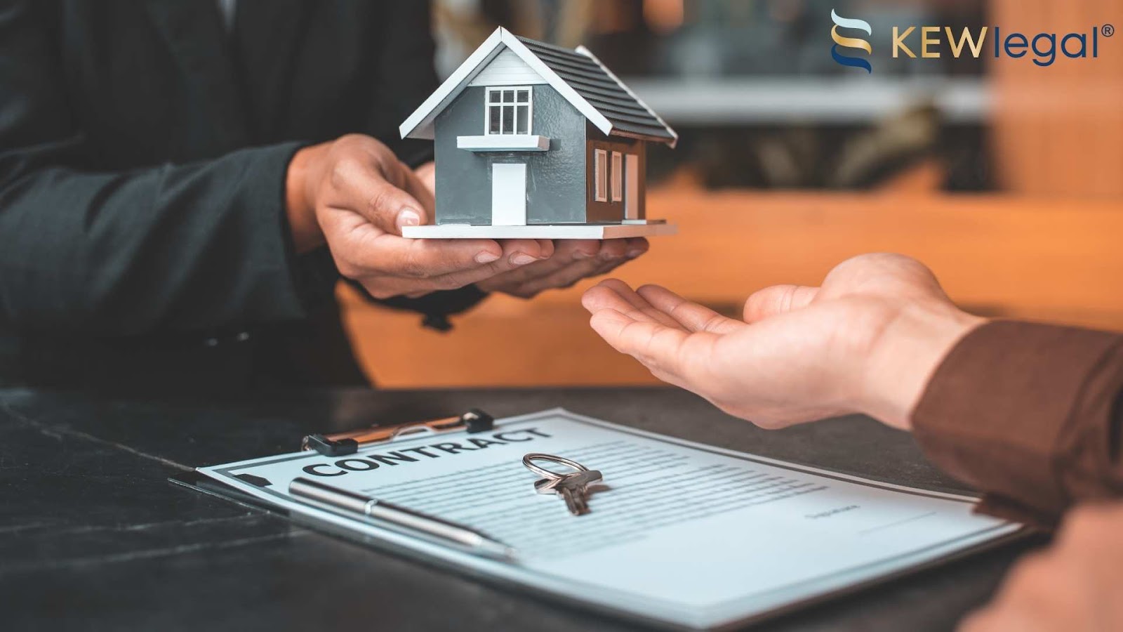Real estate contract with model house and keys.