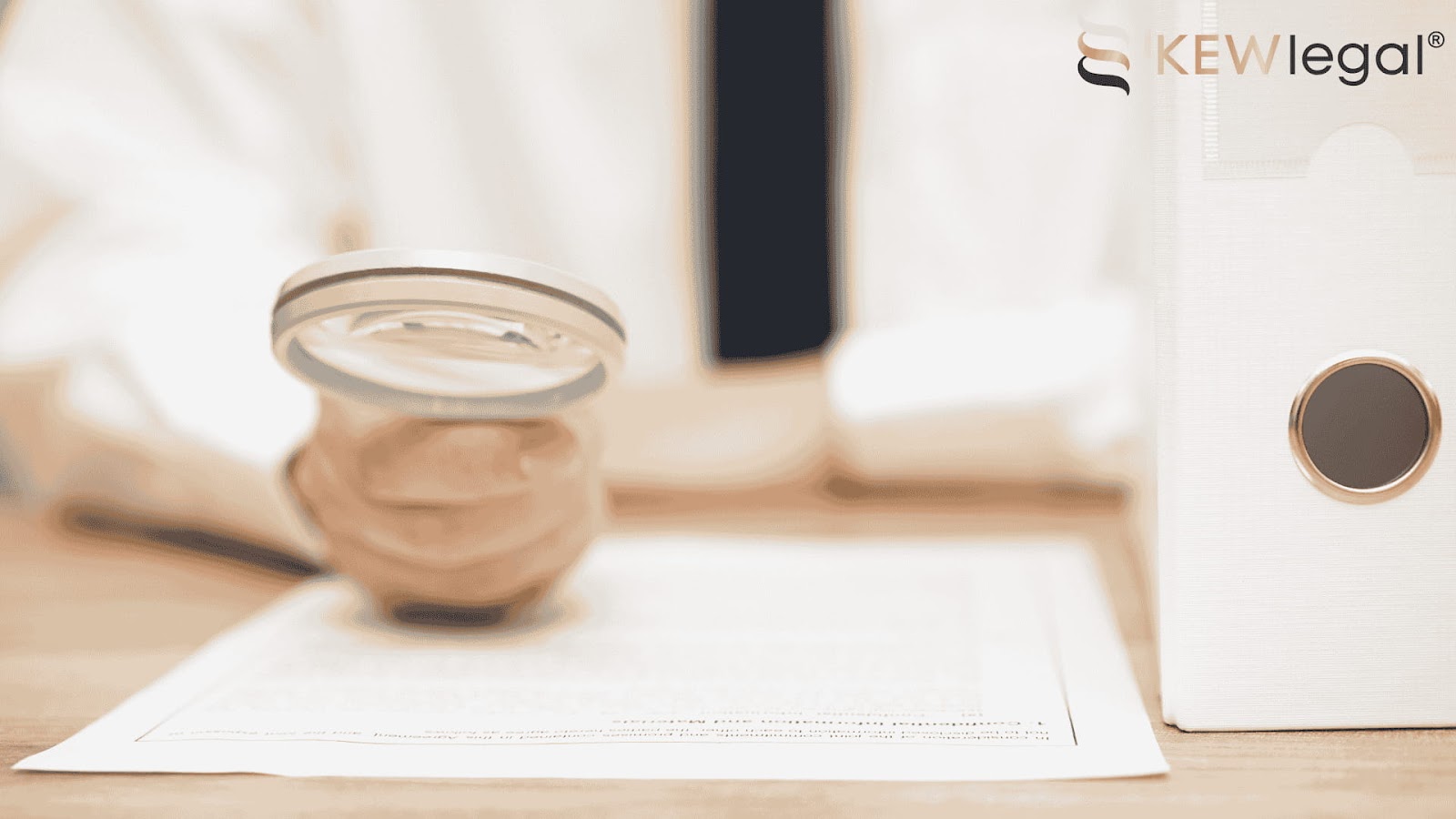 Magnifying glass and document on desk, legal context.