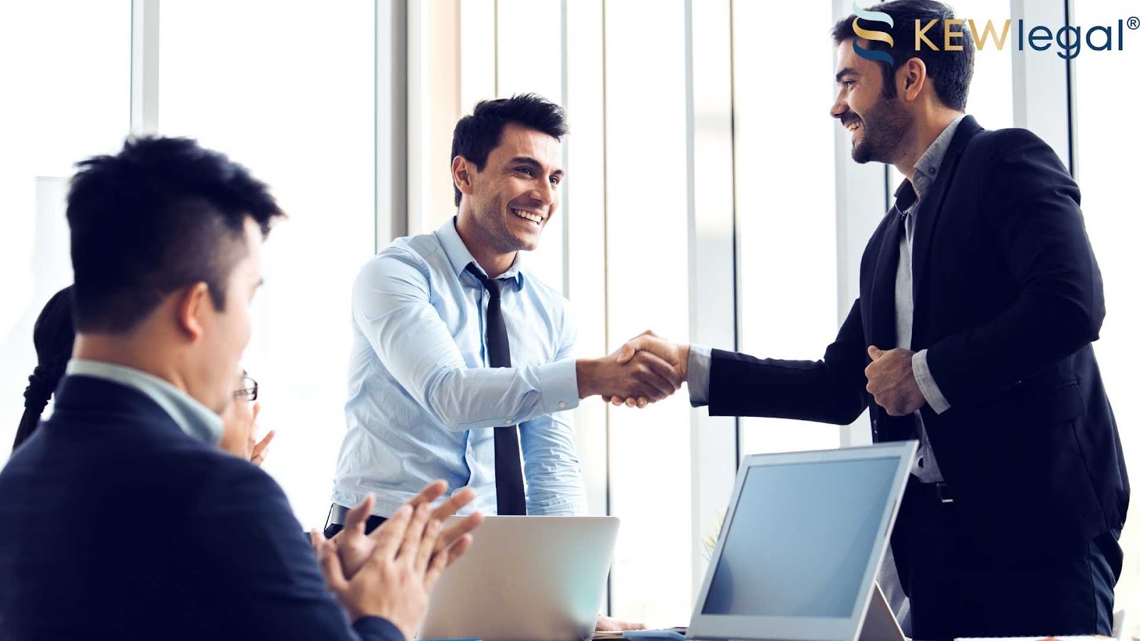 Businessman handshake in office meeting room.
