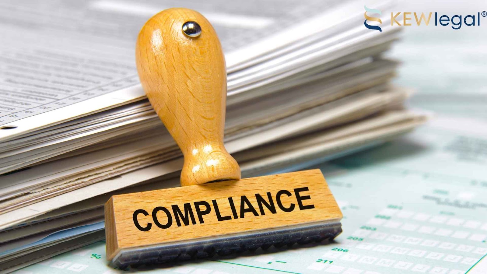 Compliance rubber stamp on documents pile