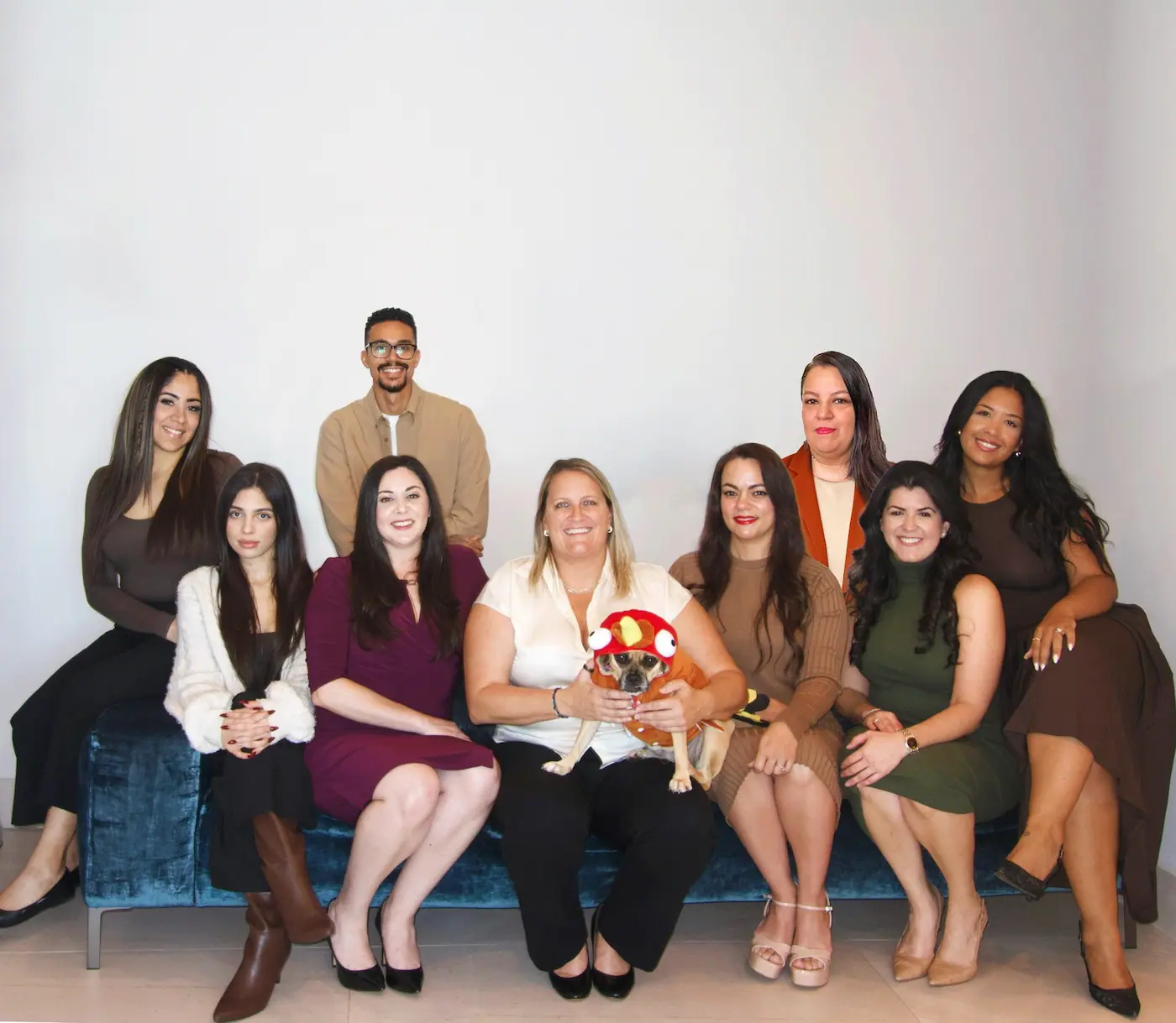 Group photo of smiling team with dog
