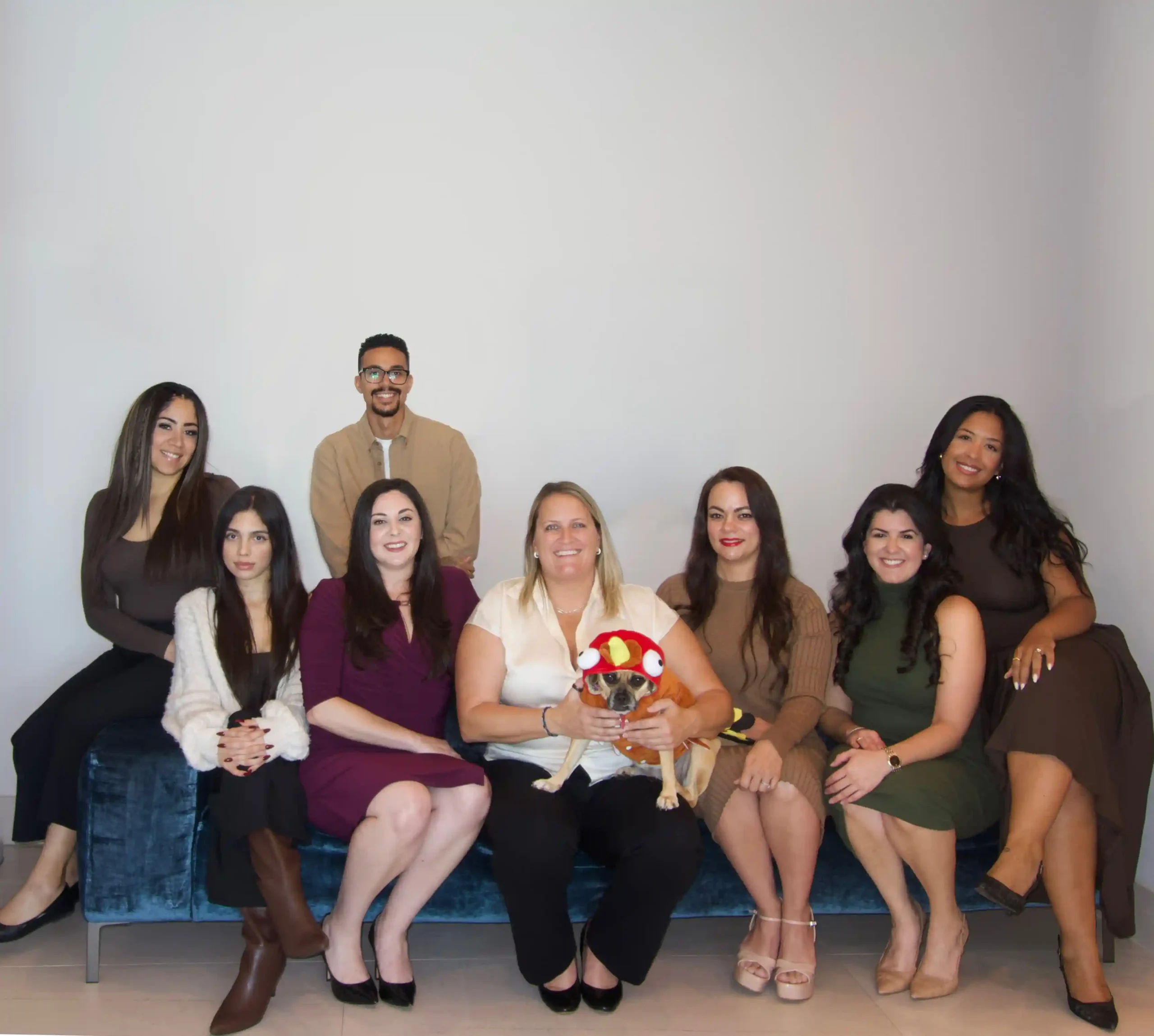 Group of people smiling with a dog