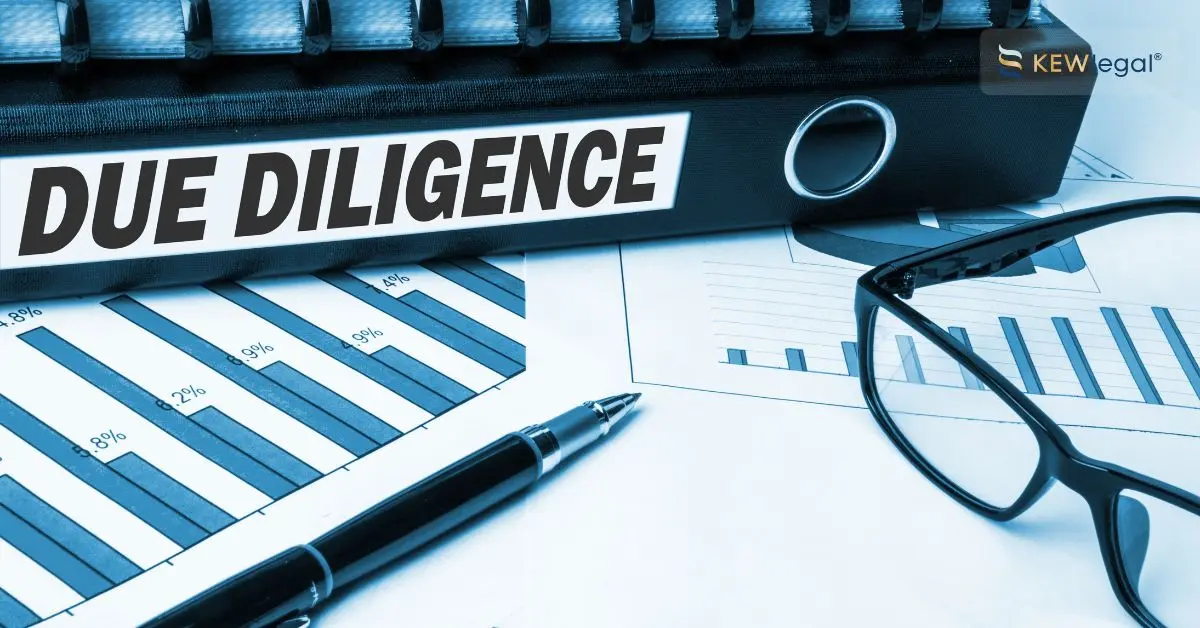 Due diligence binder with charts, pen, and glasses